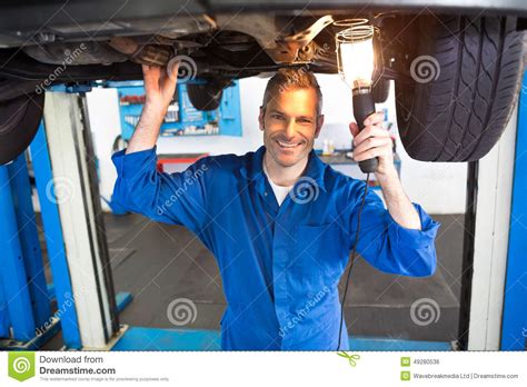 Mechanic Using Torch To Look Under Car Stock Photo Image Of Worker