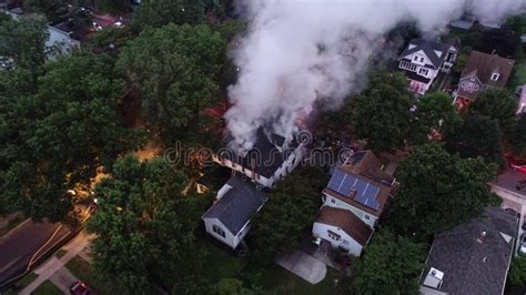 Aerial View Of Fire Trucks And Apparatus On Scene Of House Fire Stock