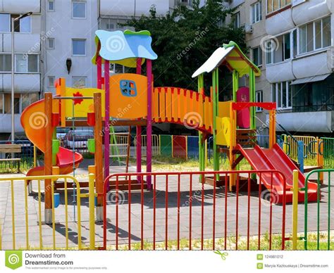 Colorful Children`s Playground With Slides And Swings In The Courtyard