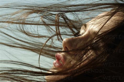 Caucasian Woman With Hair Blowing In Wind Stock Photo