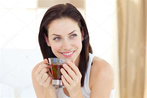 Attractive Woman Drinking Tea Stock Photo By ©wavebreakmedia 10295485
