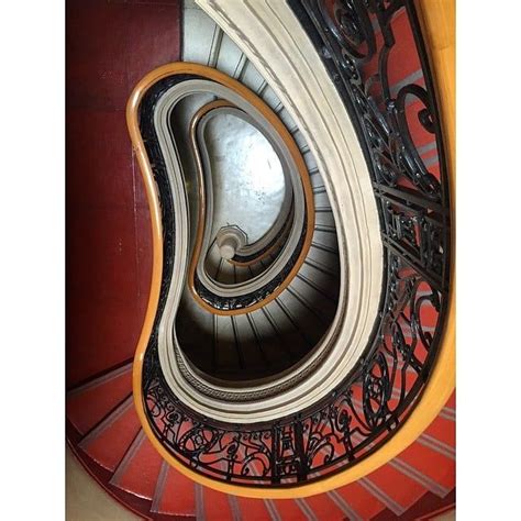A Spiral Staircase With Wrought Iron Railings