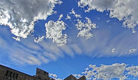Fluffy Cumulus Clouds Contrasting With Altocumulus Undulatus Gravity