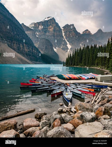 Moraine Lake And Boat Kayak Canoe With Mountains Of Banff National Park