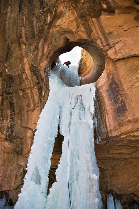 A Man Ice Climbing A Frozen Waterfall Photograph By Whit Richardson