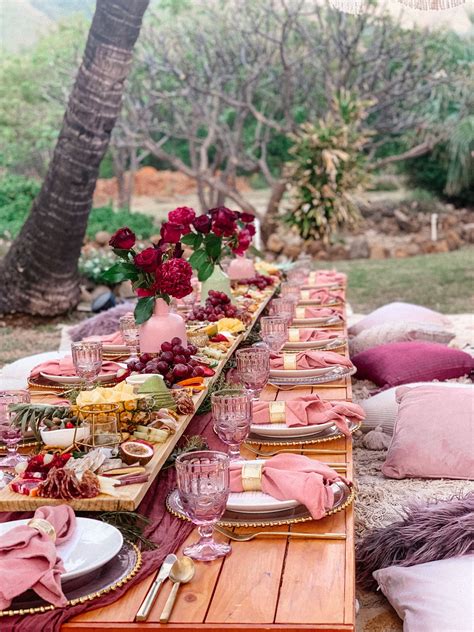 A Long Table Set Up With Plates And Place Settings For An Outdoor