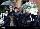 Colin Hendry puts his arm around son Callum as the coffin of Denise ...