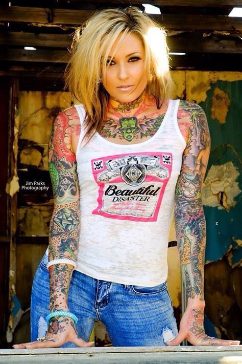 A Woman With Tattoos On Her Arms And Chest