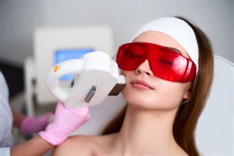 Beautician Doctor Doing Laser Rf Rejuvenation For Pretty Young Woman