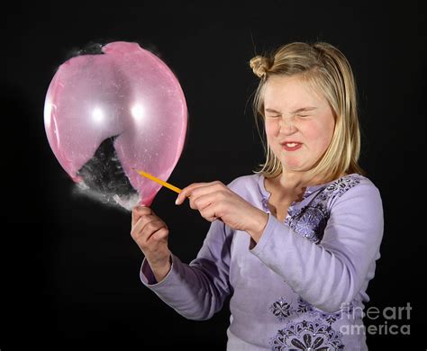 girl popping a balloon photograph by ted kinsman