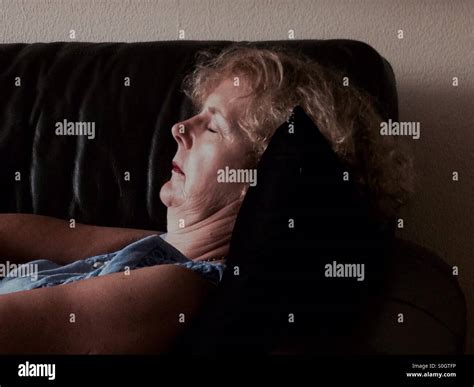 Mature Woman Sleeping On Couch Stock Photo Alamy