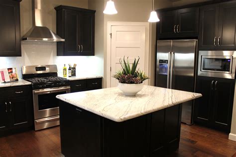 Dark kitchen cabinets are stunning, and picking the right countertop color to pair with your dark cabinets can make all the difference on your kitchen's style. How to Choose Between Light and Dark Granite… - Katie Jane ...