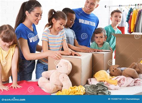 Volunteers With Children Sorting Donation Goods Stock Image Image Of