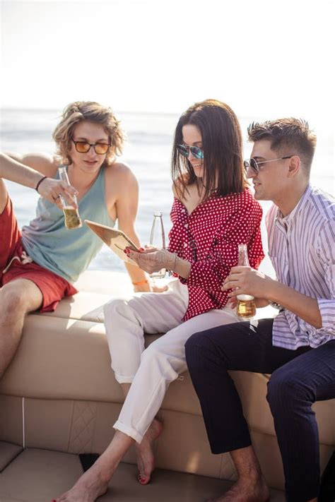 Yacht Drinking Beers While Talking Group Of Friends Having Party On