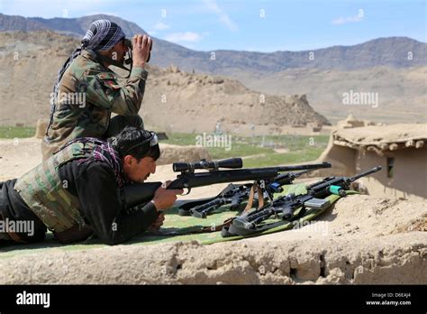 An Afghan National Army Sniper Team With The 6th Special Operations