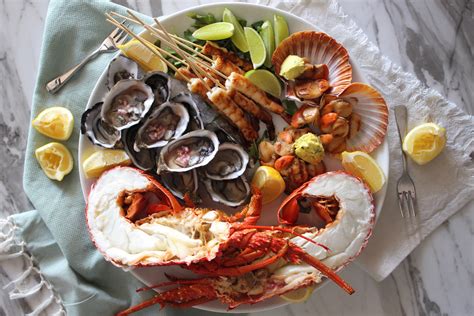 Seafood Platter With Fresh Lobster Oysters Charred Lime Prawns And