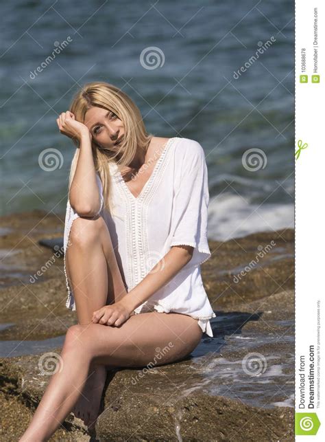 Îlonde Woman Sitting on Sea Rocks Stock Photo Image of attractive beautiful