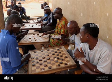 Men Playing Checkers Board Game In Esiam Ghana West Africa Stock