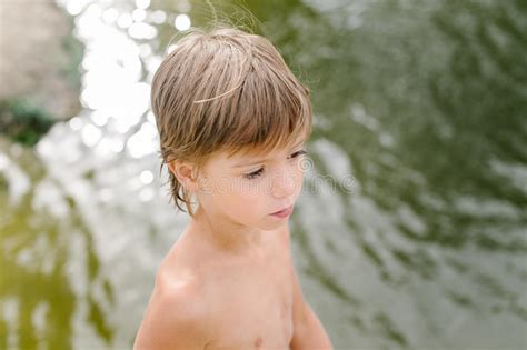 Little Boy Near Water At The Beach On Hot Summer Day Stock Photo