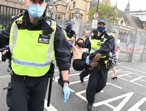 Topless Extinction Rebellion Protesters Chained To Railings In Climate
