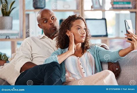 Couple Selfie And Funny Face On Sofa In Home Living Room Bonding Or Having Fun Interracial