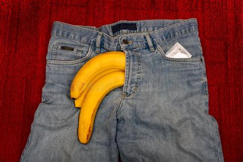 Imitation Of An Erect Penis In Jeans With A Condom Protruding From The Pants In The Form Of A