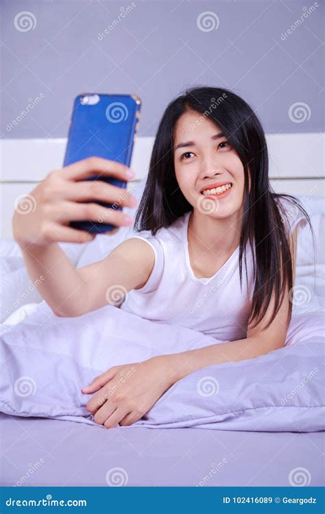 Woman Taking Selfie On Bed In Bedroom Stock Image Image Of Relax Pillow 102416089