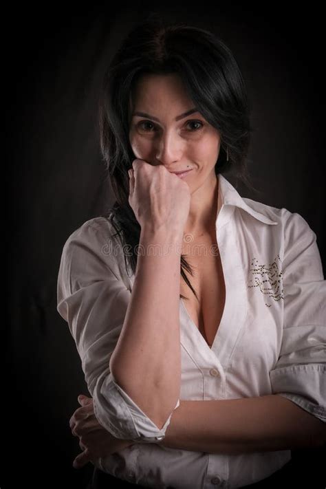 Portrait Of Beautiful Mature Brunette Woman Dressed In White Shirt Isolated On Black Background