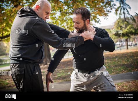 kapap instructor demonstrates street fighting self defense technique against holds and grabs
