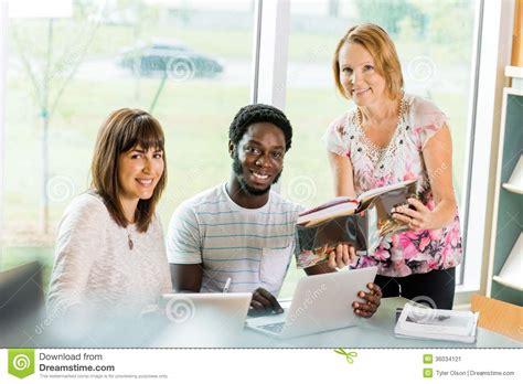 Librarian Assisting College Students In Library Stock Image Image Of