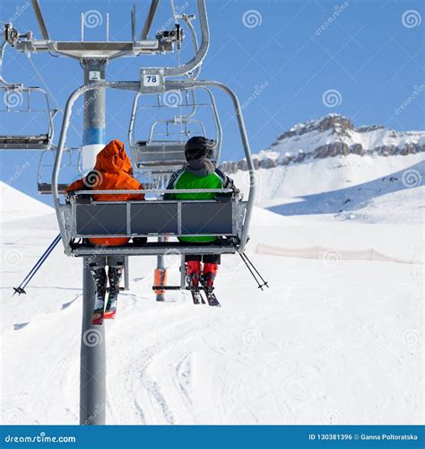 Two Skiers On Chair Lift And Snowy Ski Slope Stock Photo Image Of
