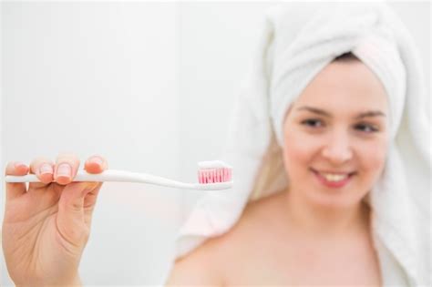Premium Photo Woman In The Bathroom Brushes Her Teeth