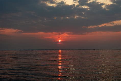 Sunset Glare Water Horizon Clouds Hd Phone Wallpaper Peakpx