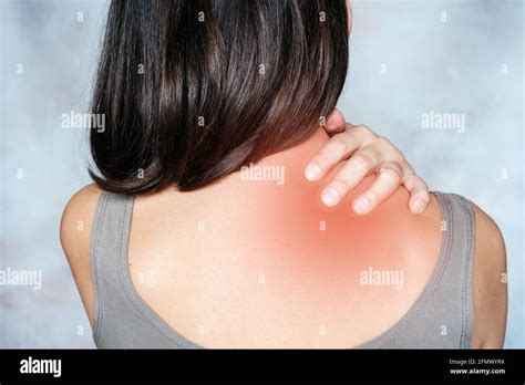 A Woman Massages Her Shoulder And Neck Pain Points Trigger Point
