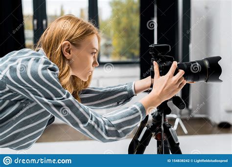 Side View Of Young Female Photographer Working With Professional Photo