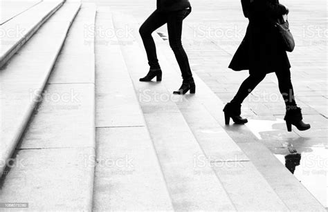 Two Young Women Walking Up And Down The Huge City Stairs Moving Past