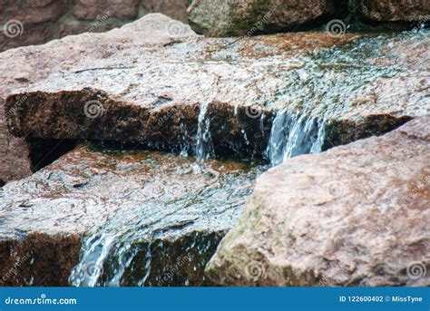 Closeup Of Water Running Down A Couple Of Rocks Stock Photo Image Of