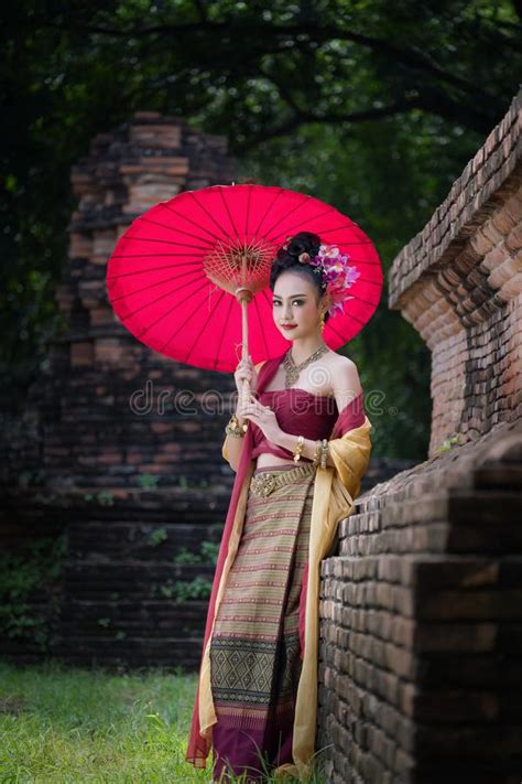 Beautiful Thai Girl In Traditional Dress Costume Red Umbrella As Stock