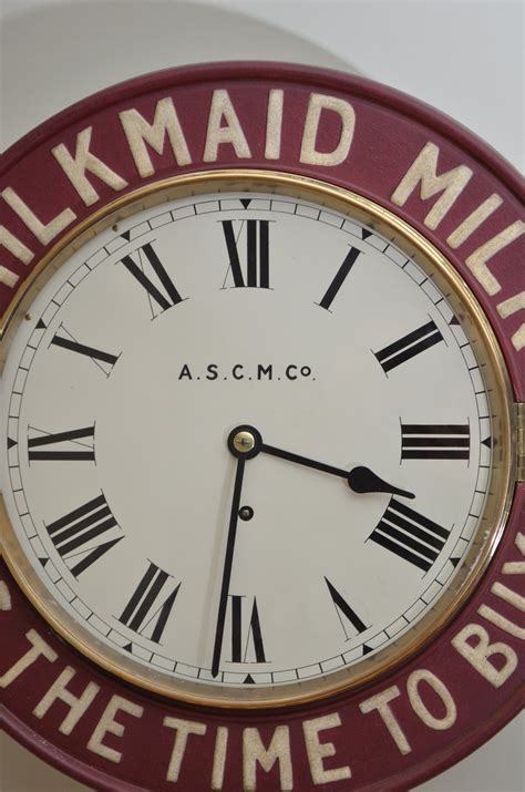 Clock hanging on wall ticking showing twelve hours. Antiques Atlas - MILKMAID Advertising Wall Clock