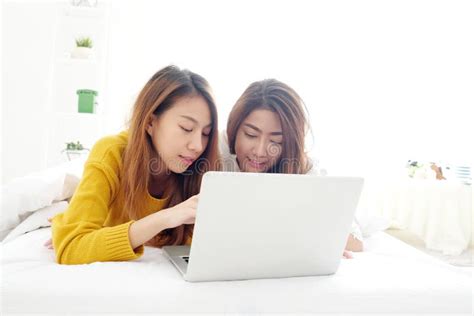 Young Cute Asia Lesbian Couple Using Laptop With Happiness At Ho Stock