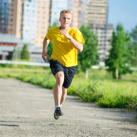 Sporty Man Jogging In City Street Park Outdoor Fitness Stock Photo