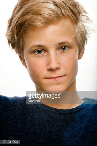 Boy With Blond Hair Blue Eyes Blue Pullover Looking Directly Into