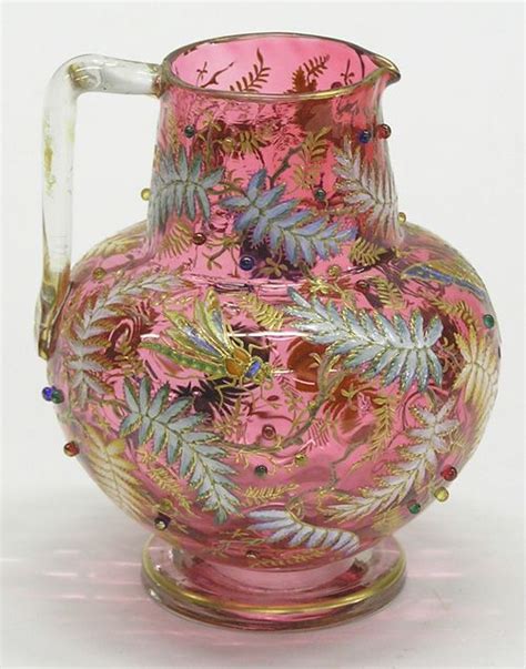 A Moser Cranberry Pitcher Applied Handle Decorated In Butterflies Insects And Leaves With