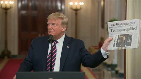 President Trump Holds Up Newspaper With Headline Trump Acquitted