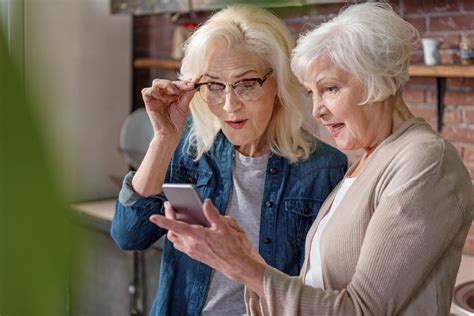 two senior women looking at a phone older adults how to plan aging