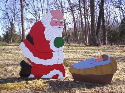 Santa Praising Kneeling Praying Before Manger Crib With Baby Jesus