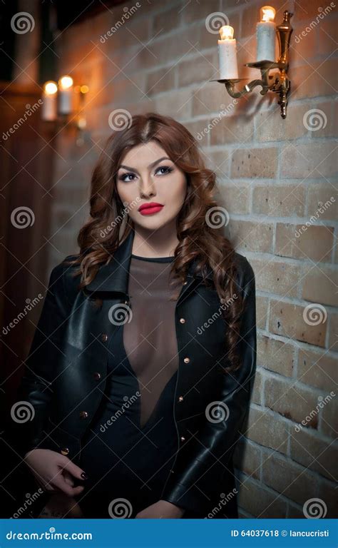 Charming Brunette With Black Leather Jacket Against Red Bricks Wall