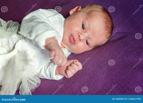 Soft Portrait Of Peaceful Sweet Newborn Infant Baby Lying On Bed While