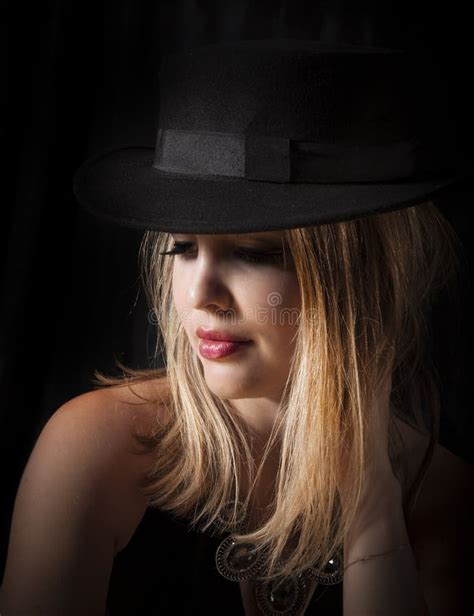 Sensual Blonde Woman With Long Hair And Black Fedora Posing In Glamor