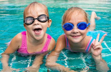 Two Little Girls Playing In The Pool — Stock Photo © Altanaka 12737655
